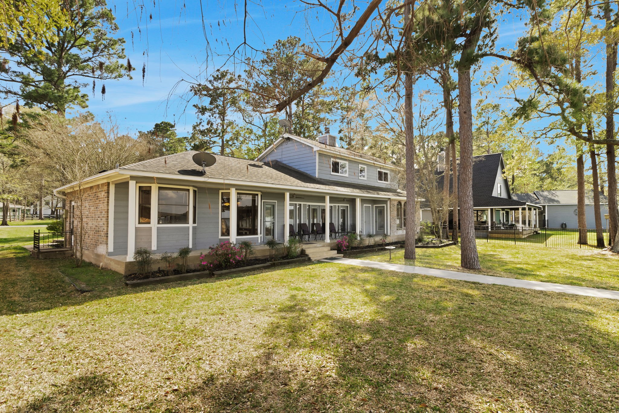 40 Pebble Beach Circle Coldspring, TX 77331 - Photo 42 of 50 View of the back of the home showcasing the landscaped yard and covered porch.