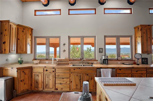 a kitchen with a window a sink and cabinets