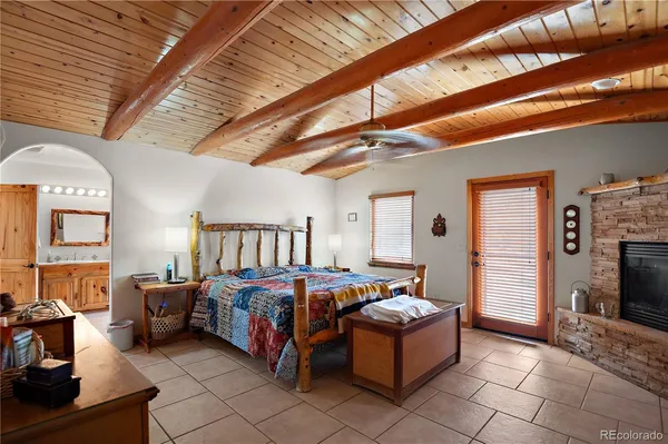 a bedroom with a bed and a tv on the dresser