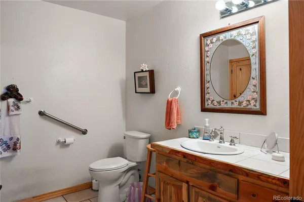 a bathroom with a toilet sink and mirror