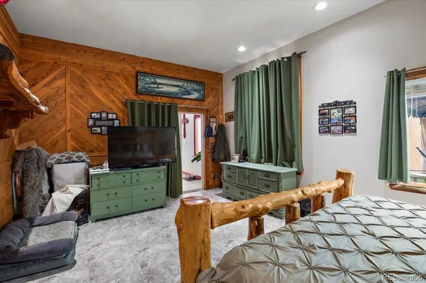 a bedroom with furniture and a large mirror