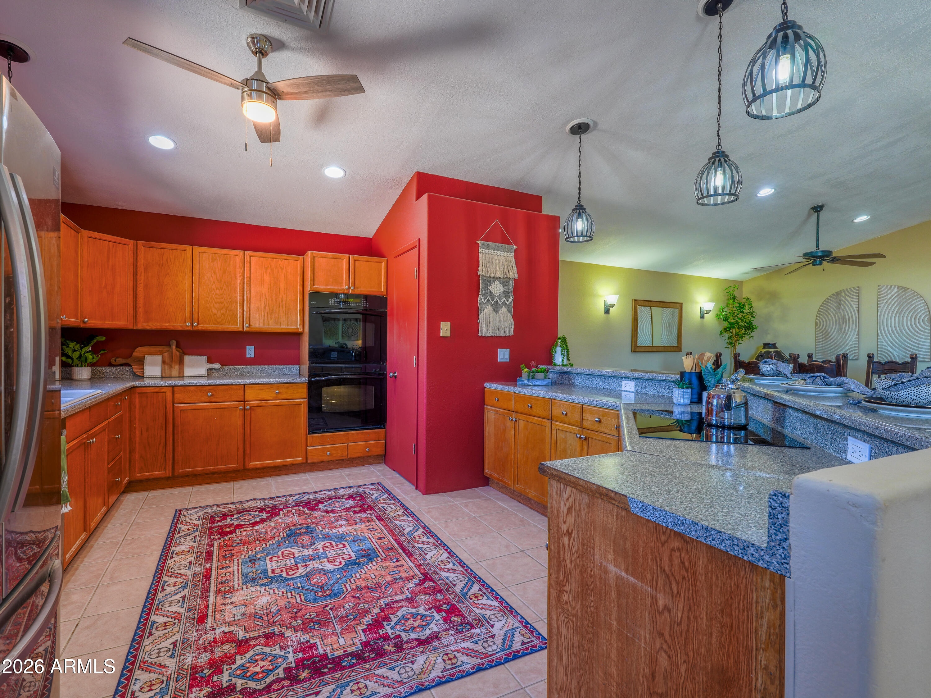 1224 North Acacia Road Apache Junction, AZ 85119 - Photo 15 of 48 a kitchen with stainless steel appliances granite countertop a sink dishwasher and a flat screen tv