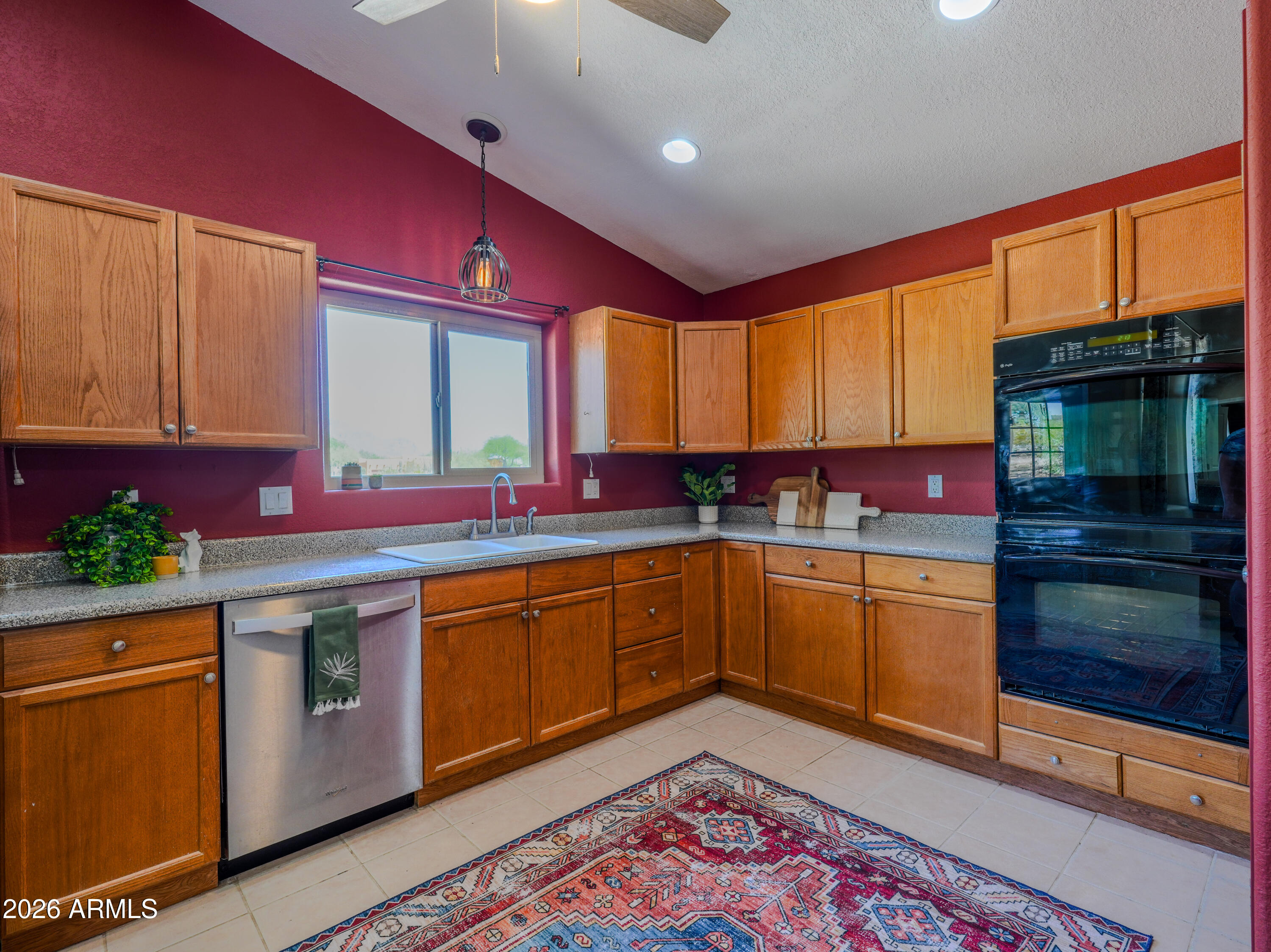 1224 North Acacia Road Apache Junction, AZ 85119 - Photo 16 of 48 a kitchen with stainless steel appliances granite countertop a stove a sink and a microwave