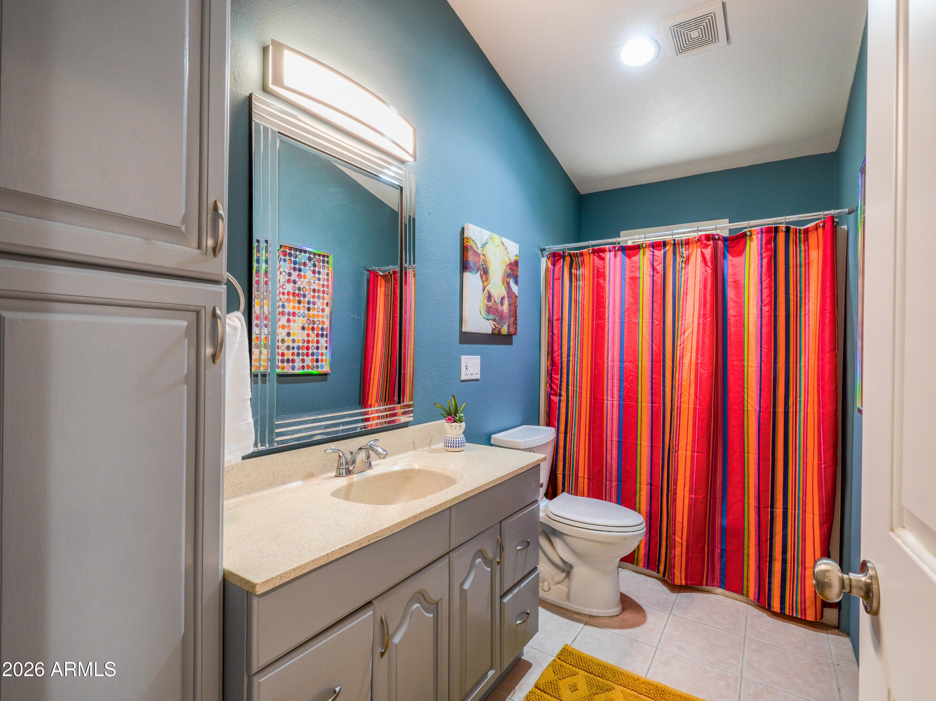 1224 North Acacia Road Apache Junction, AZ 85119 - Photo 32 of 48 a bathroom with a sink a toilet and a mirror
