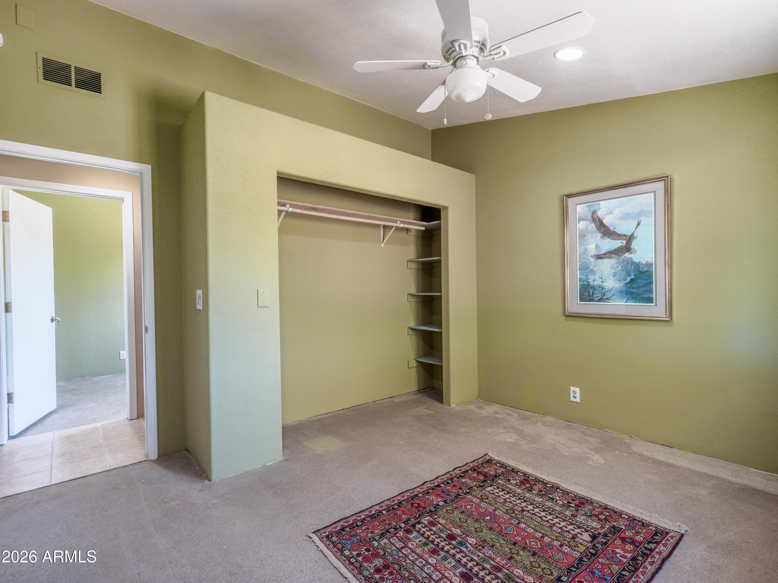 1224 North Acacia Road Apache Junction, AZ 85119 - Photo 37 of 48 a bedroom with a bed and a chandelier