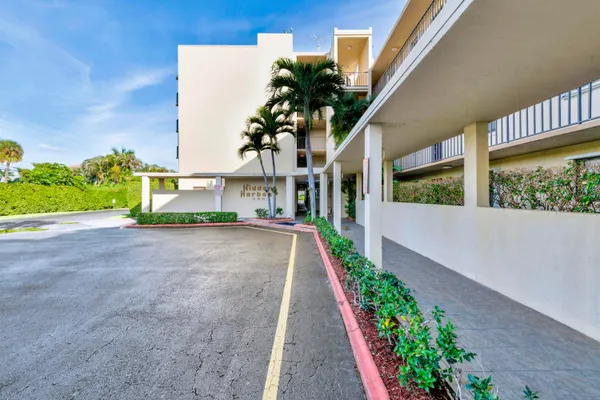 a view of a garden with a building in the background