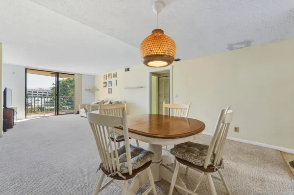 a view of a room that has a table and chairs in it