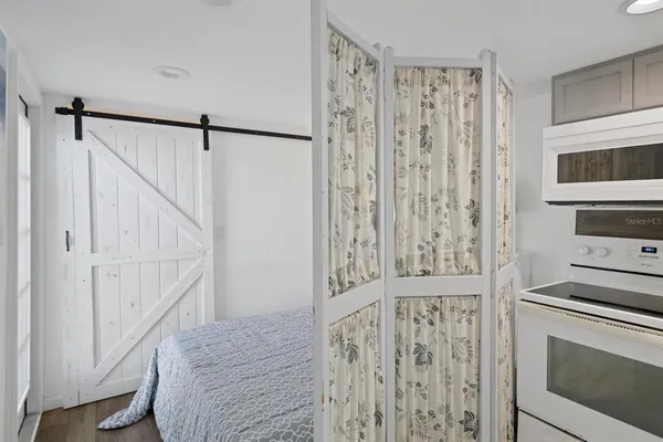 a hallway with cabinets and wooden floor