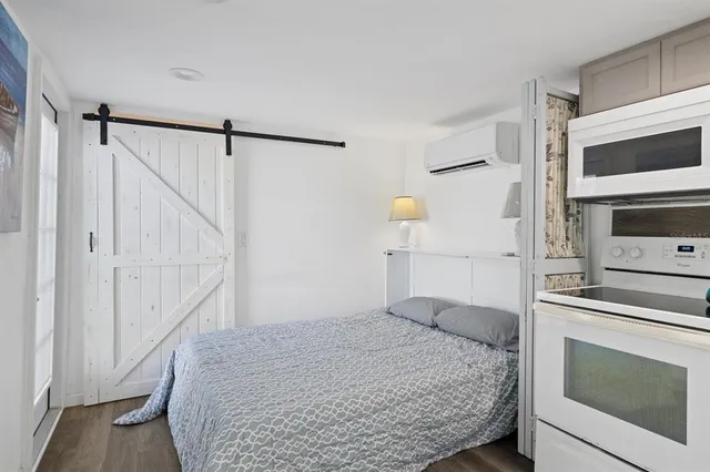 a bedroom with a bed and a fireplace