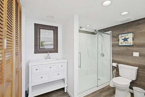 a bathroom with a toilet a sink and shower
