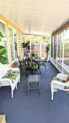 a living room with furniture and floor to ceiling windows
