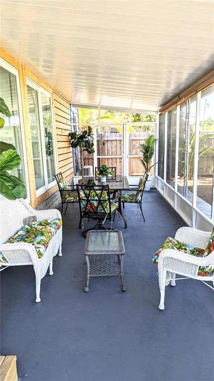 Undisclosed Address Holiday, FL 34691 - Photo 16 of 32 a living room with furniture and floor to ceiling windows