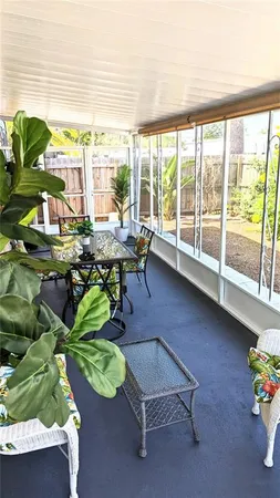 a living room filled with furniture and a floor to ceiling window