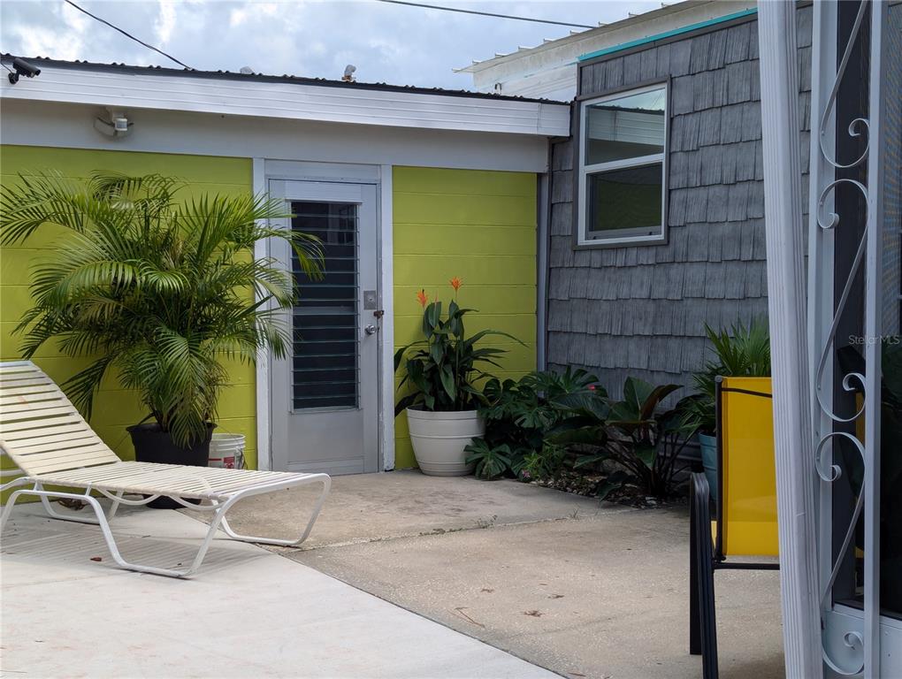 Undisclosed Address Holiday, FL 34691 - Photo 21 of 32 a view of a patio with table and chairs potted plants and large tree