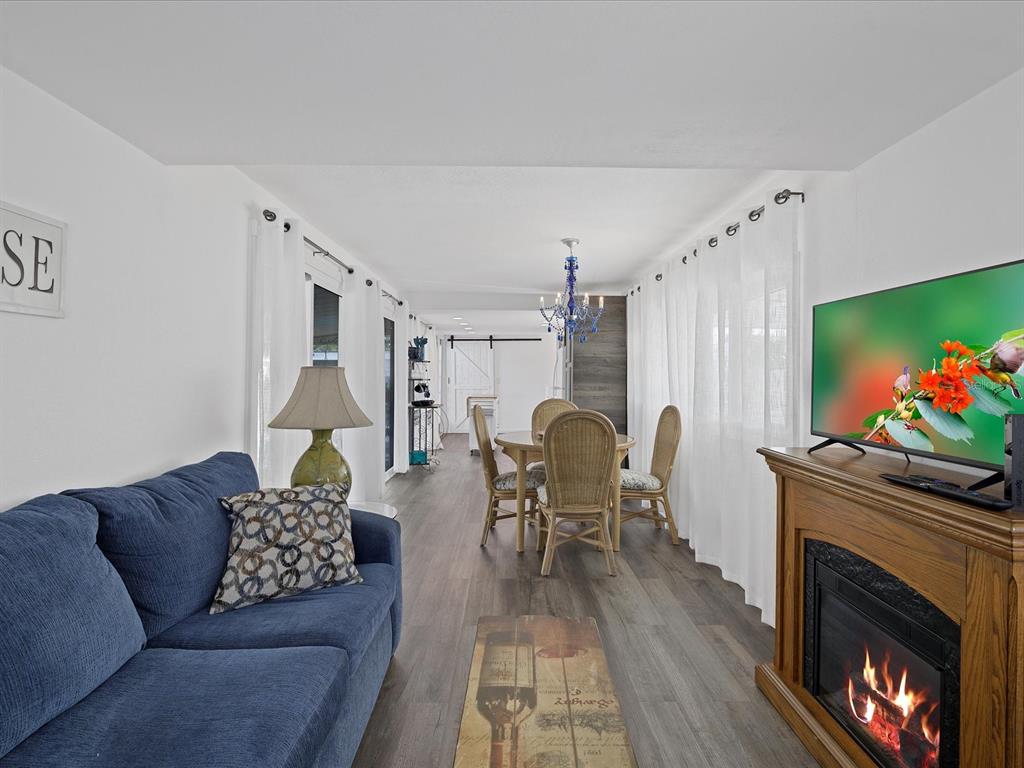 Undisclosed Address Holiday, FL 34691 - Photo 4 of 32 a living room with furniture and a fireplace