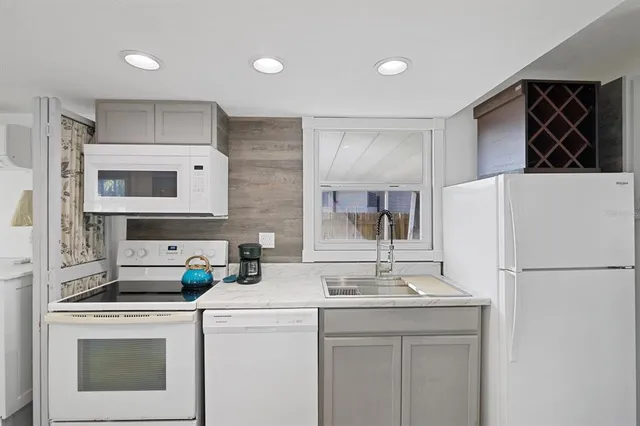 a kitchen with a sink a stove and refrigerator