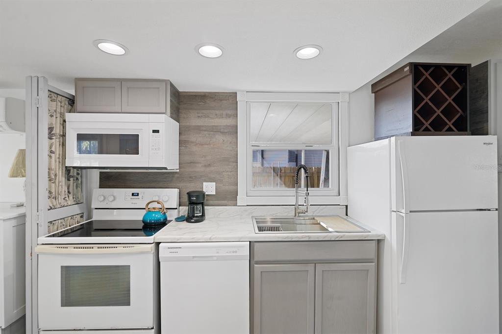 Undisclosed Address Holiday, FL 34691 - Photo 8 of 32 a kitchen with a sink a stove and refrigerator
