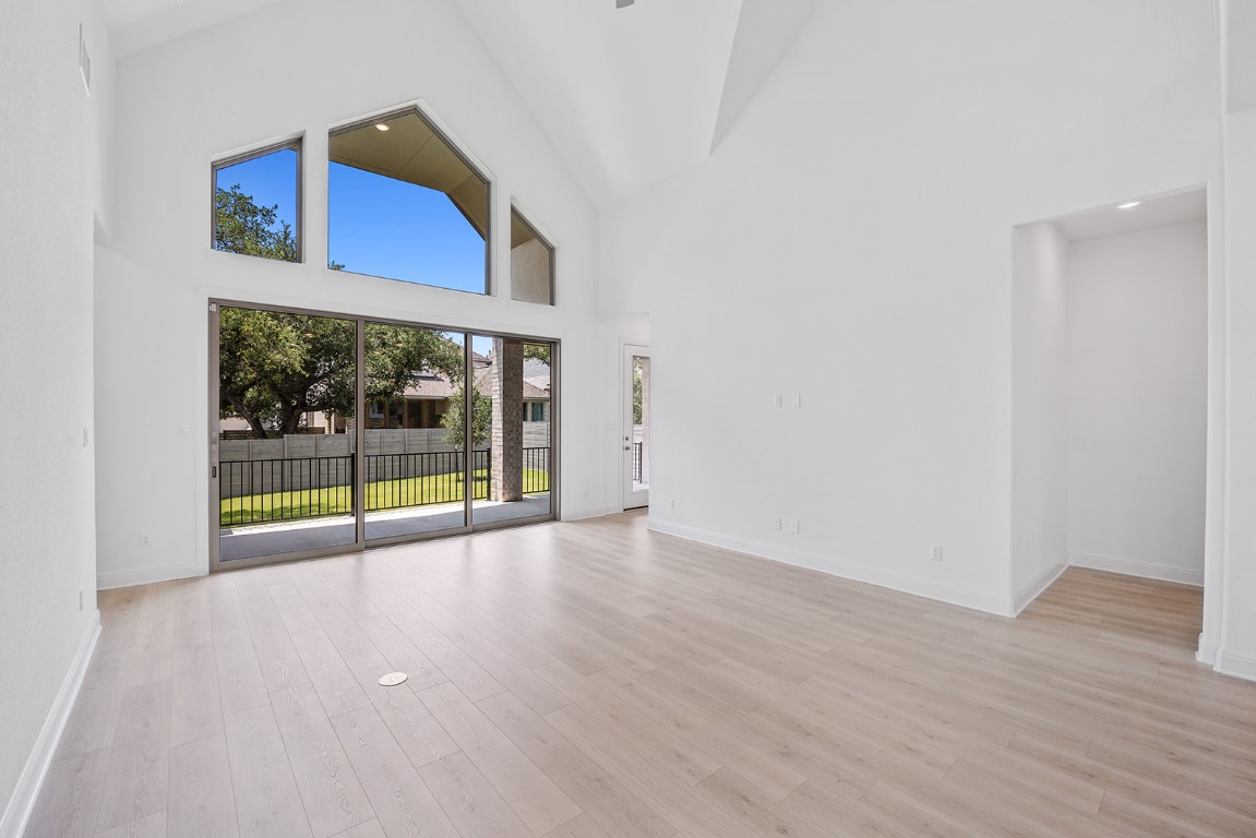 228 Running Fawn Georgetown, TX 78628 - Photo 6 of 29 a view of an empty room with wooden floor and windows