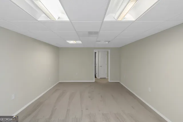 an empty room with a ceiling fan and window