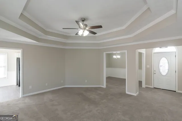 an empty room with closet and a ceiling fan