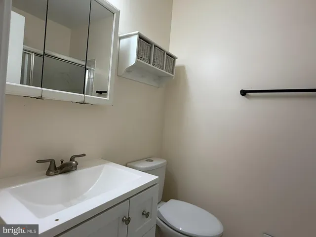 a bathroom with a sink toilet and mirror