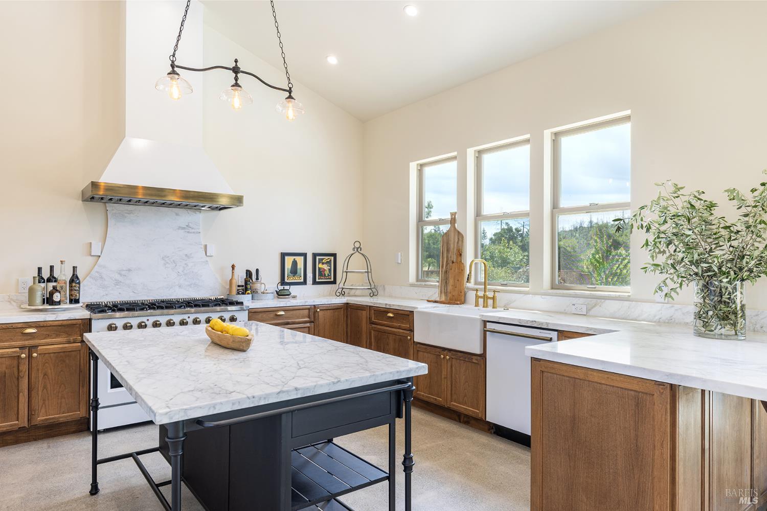 753 Sunnyside Road St. Helena, CA 94574 - Photo 15 of 55 a kitchen with a sink a stove and chairs