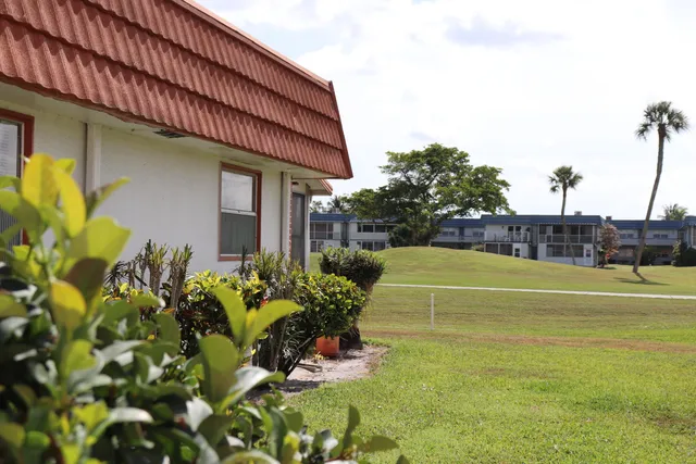 a view of a swimming pool with a yard