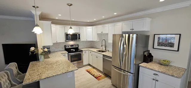 a kitchen with a refrigerator a microwave a sink and a stove