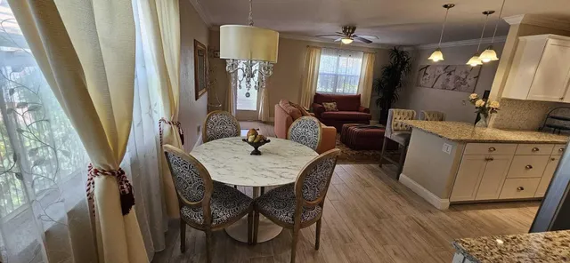 a view of a dining room with furniture and a chandelier