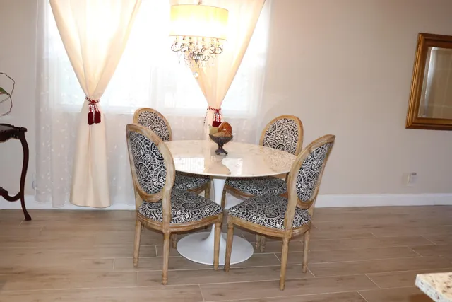 a dining room with furniture a rug and wooden floor