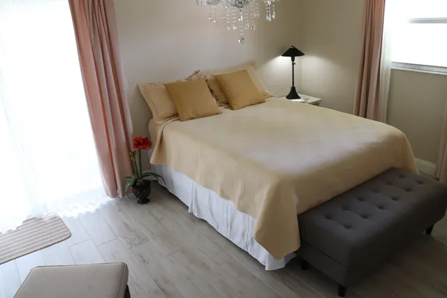 a bed sitting in a bedroom next to a window