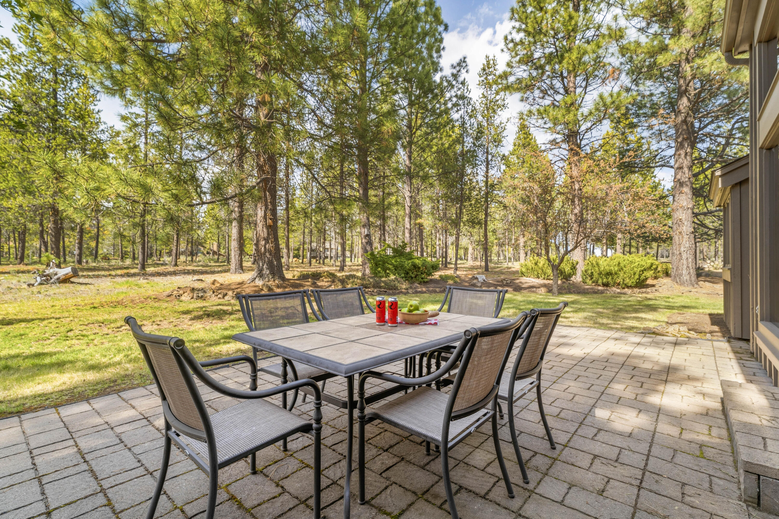 17866 Grouse Lane, Unit 3 Sunriver, OR 97707 - Photo 3 of 61 a patio with table and chairs and couches with wooden floor and fence