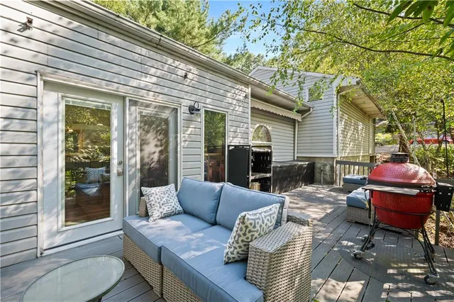 a view of a patio with couches table and chairs and potted plants
