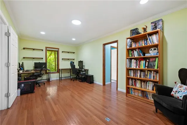 a living room with furniture and a book shelf