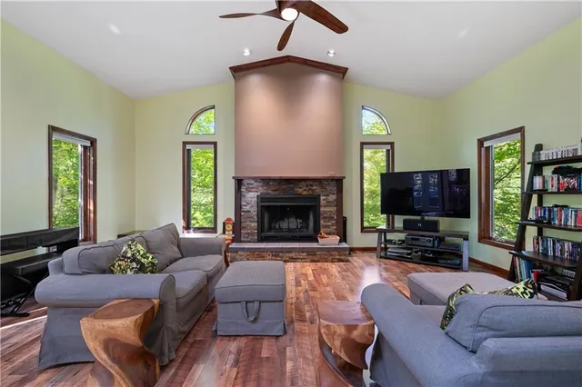 a living room with furniture flat screen tv and a fireplace
