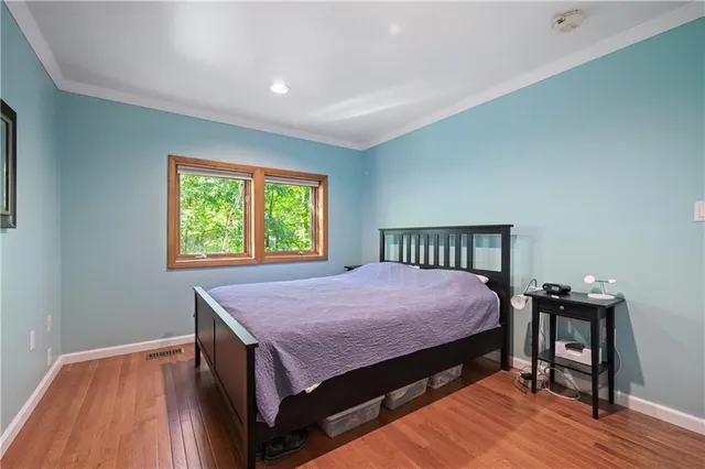 a bed sitting in a bedroom next to a window