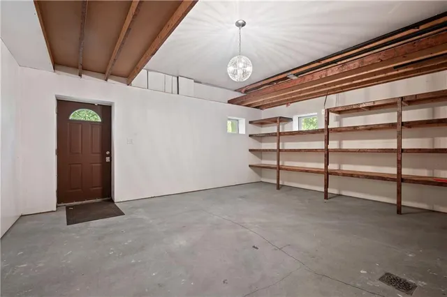 a view of a room with stairs and a chandelier