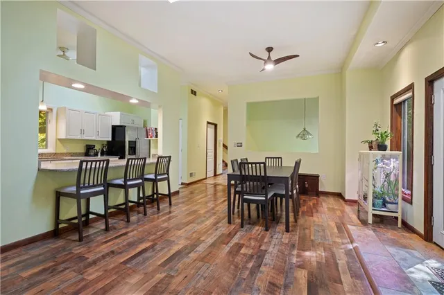 a view of a dining room with furniture and wooden floor