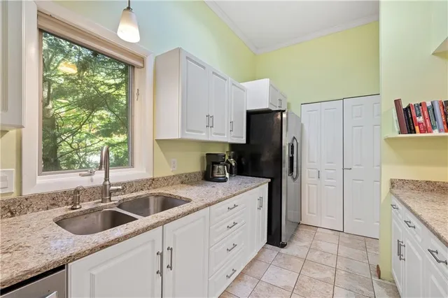 a kitchen with a sink stove and refrigerator