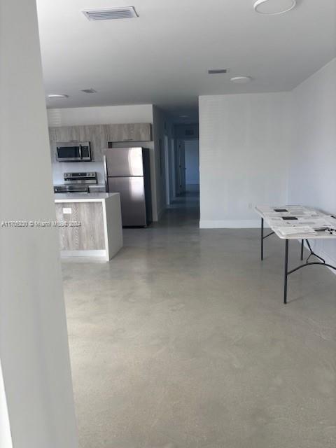 a view of kitchen with furniture and stainless steel appliances