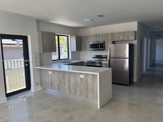 2011 Northwest 26th Street, Unit 2011 Miami, FL 33142 - Photo 7 of 7 a kitchen with a refrigerator a microwave a sink and cabinets