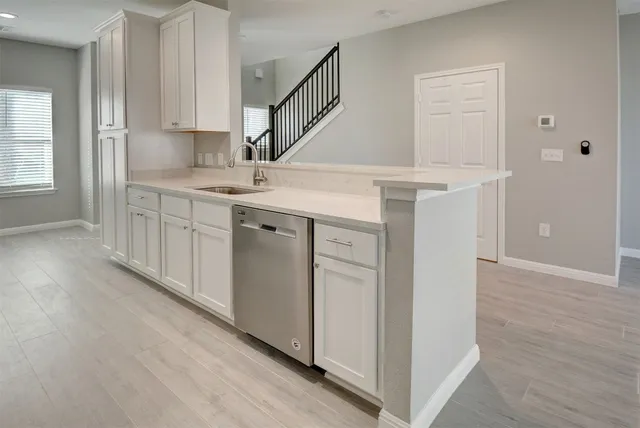 a view of kitchen with stainless steel appliances refrigerator oven and cabinets