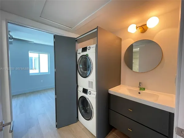 a bathroom with a sink mirror and toilet