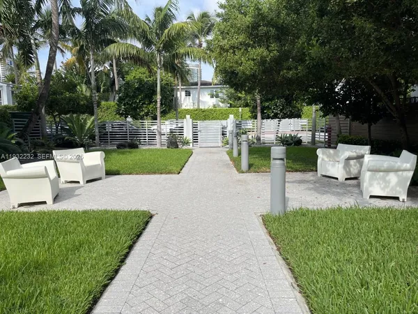 a view of a patio with couches and a big yard