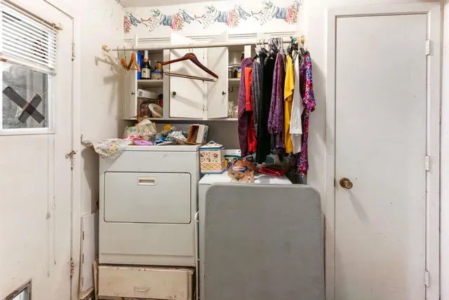 a view of walk in closet with clothes