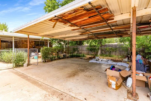 a view of a backyard with table and chairs potted plants