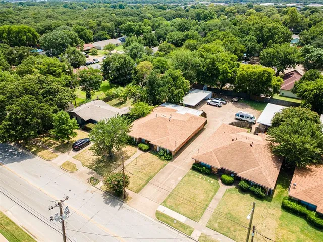 an aerial view of a house with yard and parking