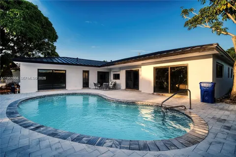 an aerial view of a house with swimming pool garden and patio