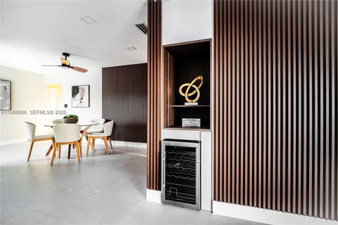 a view of a livingroom with a chair and potted plant