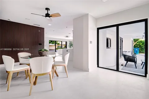 a living room with furniture and a kitchen area
